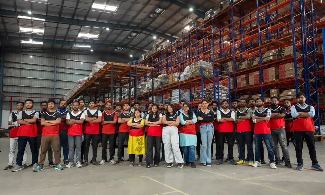AAJ SCM team standing together inside warehouse - local hiring