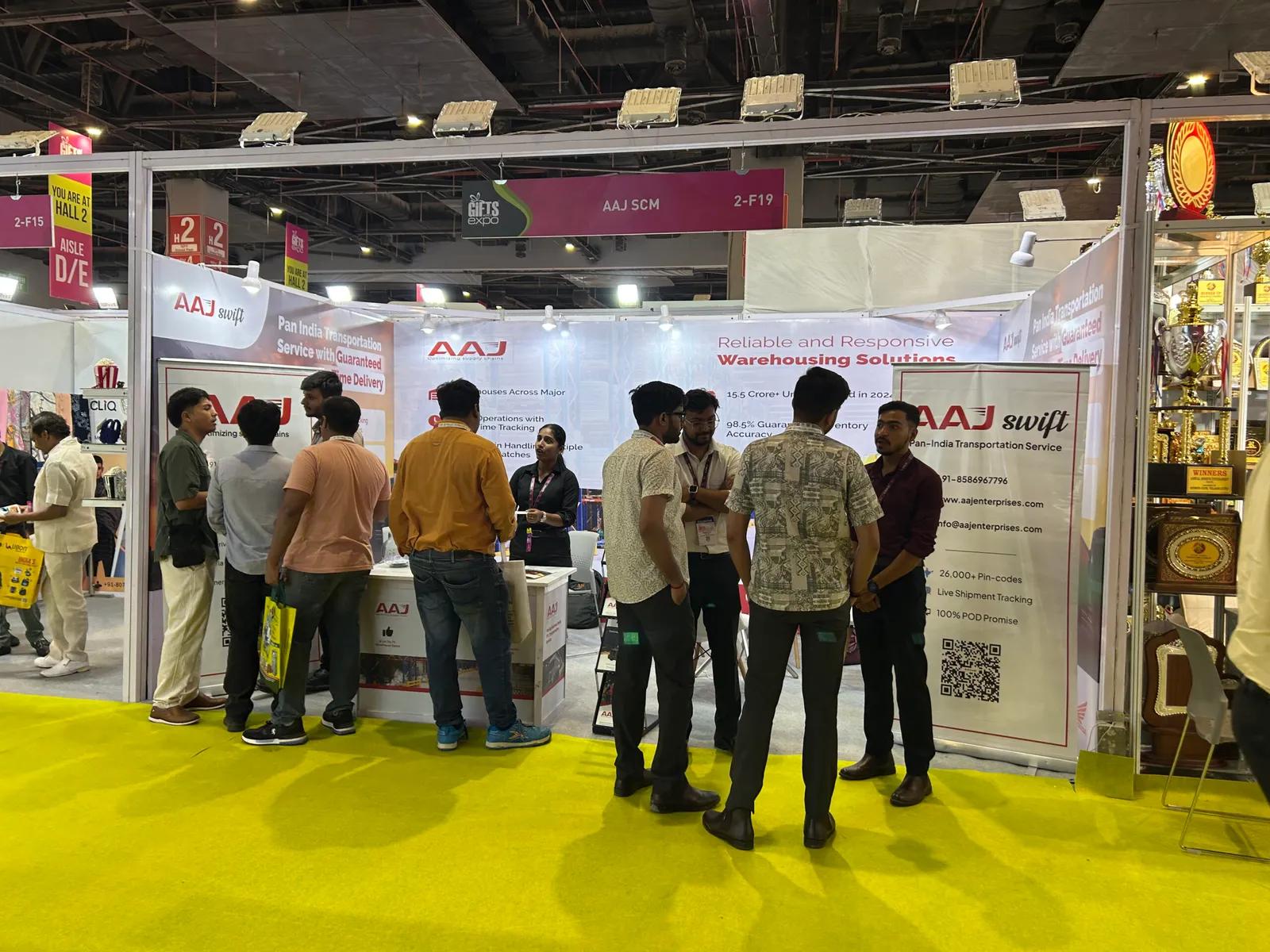 AAJ SCM team members engaging with attendees at their booth during Gifts World Expo 2025, discussing 3PL warehousing and logistics solutions.